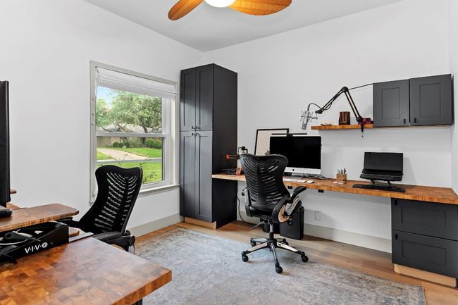 Office with a ceiling fan and light wood-type flooring | Image 18