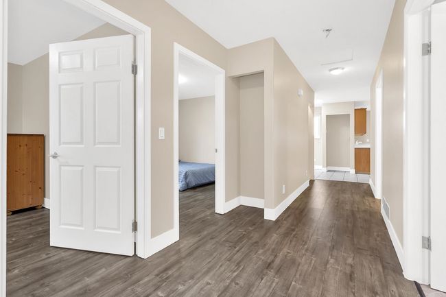Hall featuring dark wood-style floors, baseboards, and visible vents | Image 26
