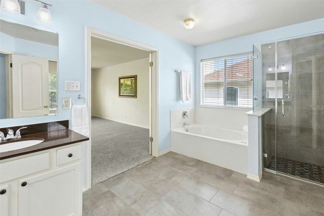 Primary bath has soaking tub and separate shower | Image 14