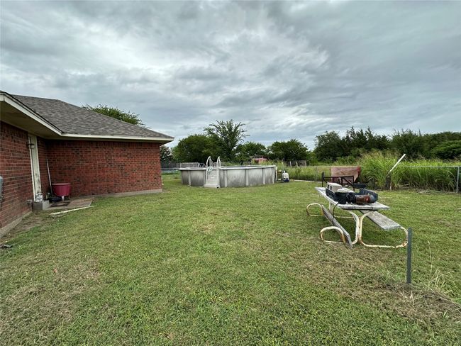View of grassy yard featuring an outdoor pool | Image 18