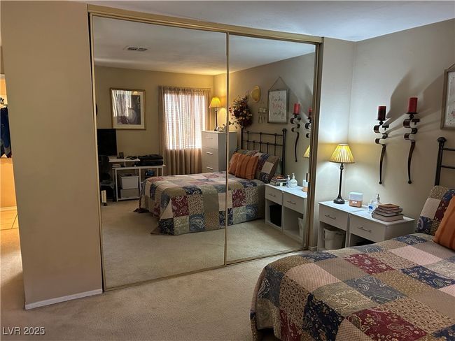 Carpeted bedroom with a closet | Image 21
