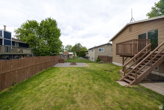 View of yard featuring an outdoor fire pit, a wooden deck, and stairway | Image 27