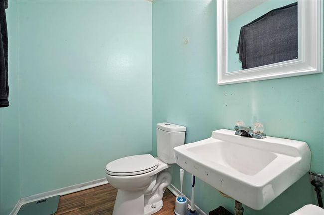 Bathroom with a sink, toilet, and wood finished floors | Image 14