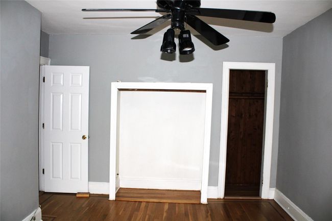 Unfurnished bedroom featuring wood finished floors, baseboards, and a ceiling fan | Image 14