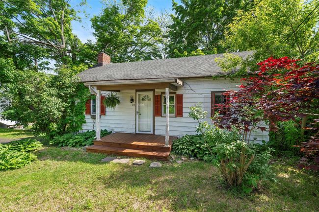 Ranch-style house with a chimney, roof with shingles, and a front lawn | Image 24