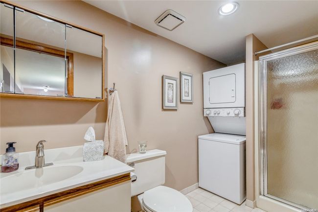 Hallway Full Bathroom with Stall Shower and Full-Size Stackable Washer & Dryer | Image 17