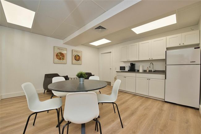 Dining area featuring light wood-type flooring, baseboards, and a drop ceiling | Image 7