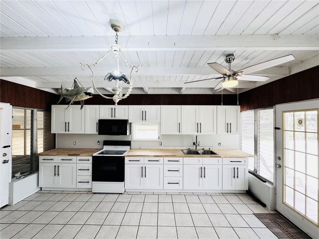 The kitchen is located between both living quarters | Image 18