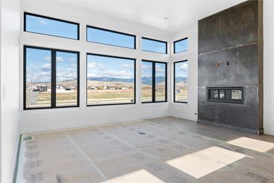 Unfurnished living room featuring a mountain view | Image 1