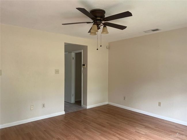 Unfurnished room featuring wood finished floors and a ceiling fan | Image 14