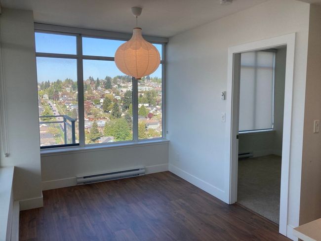 Unfurnished dining area with dark wood finished floors, a baseboard radiator, a healthy amount of sunlight, and baseboard heating | Image 10