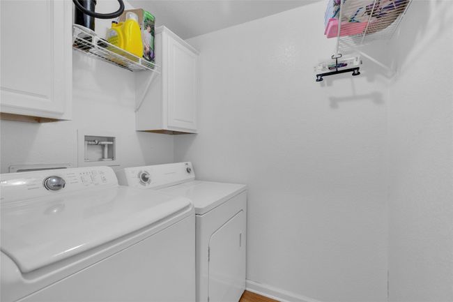 Washroom with cabinet space and washing machine and clothes dryer | Image 21