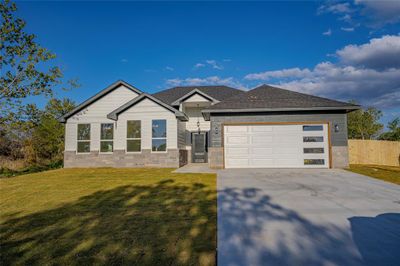 View of front of property featuring a front yard and a garage | Image 2