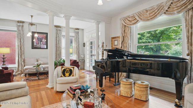 The formal living room with architectural columns separating the foyer | Image 11