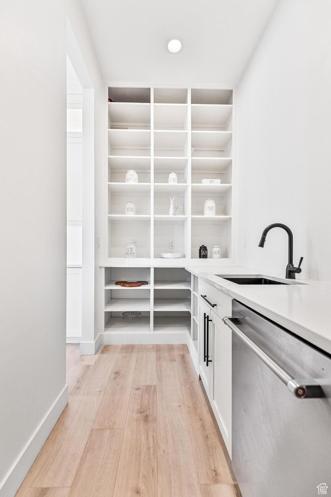 Storage area featuring a sink | Image 63
