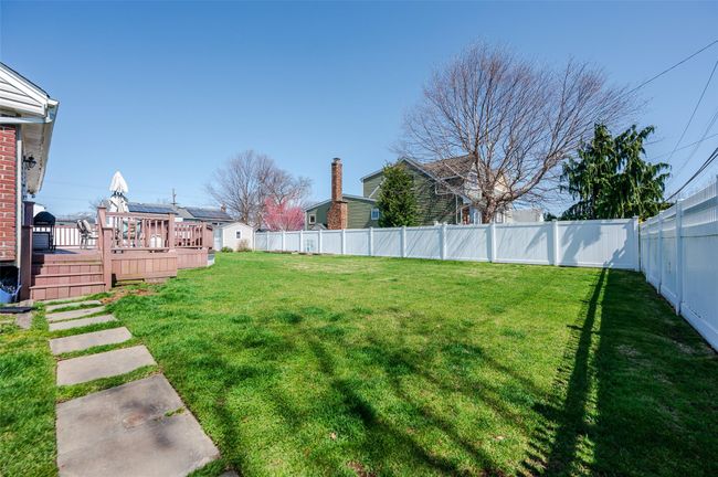 View of yard featuring a fenced backyard and a wooden deck | Image 19
