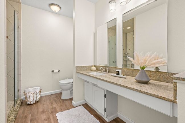 The primary ensuite showcases a soft neutral palette that enhances the natural light and views from the primary suite. | Image 12