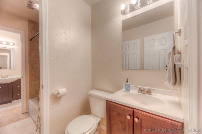 The hall bath has its own vanity and toilet and connects to the shared tub/shower in the middle. | Image 21