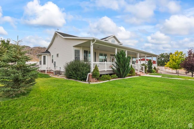 View of front of house with covered porch and a front yard | Image 99