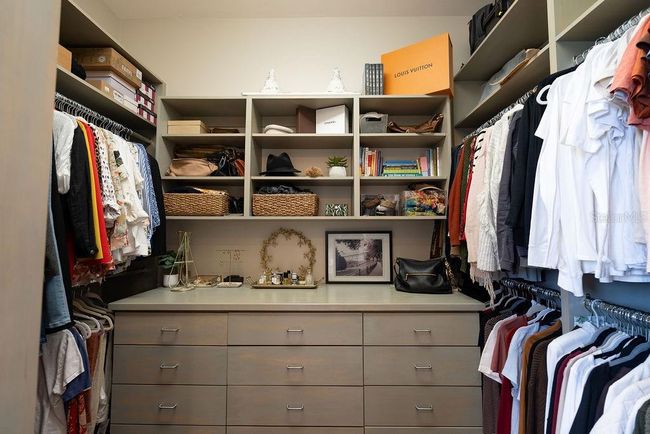 Second primary walk-in closet with built in drawers, shoe shelves and an abundance of hanging space for clothing. | Image 42