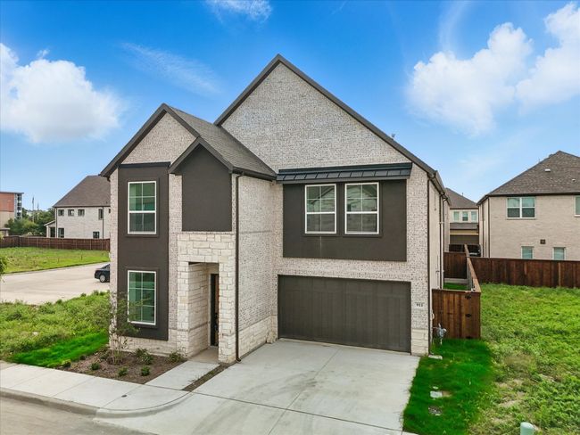 View of front of house featuring a garage, stone siding, and concrete driveway | Image 36