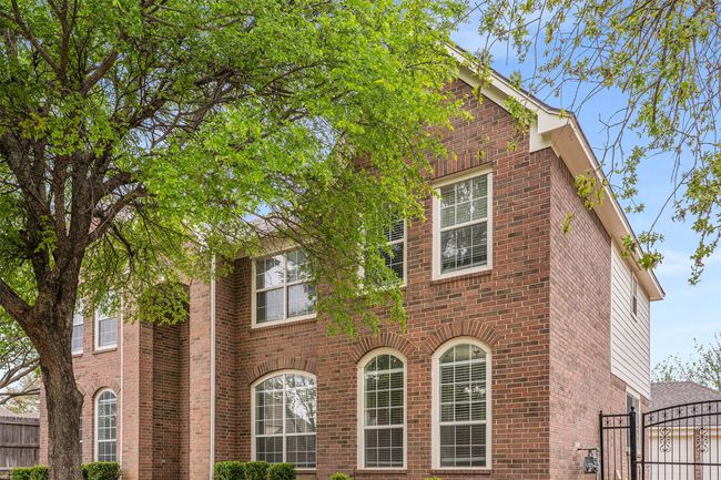 View of front of property featuring a gate, fence, and brick siding | Image 4