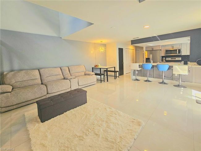 Living area featuring recessed lighting and light tile patterned floors | Image 9