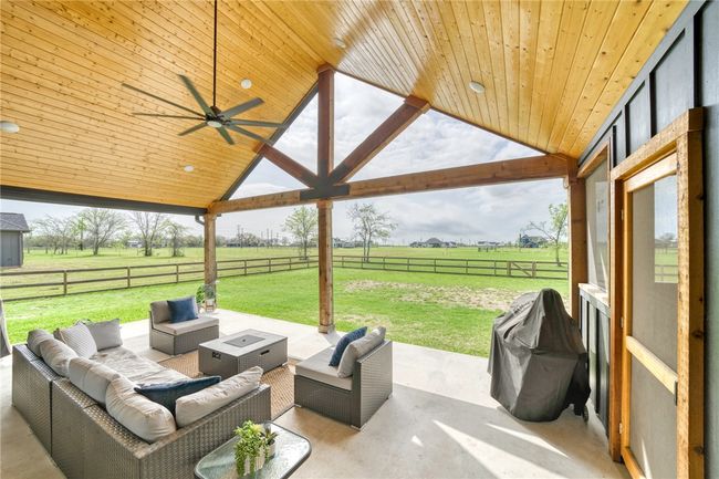View of patio / terrace with outdoor lounge area, a grill, a rural view, and ceiling fan | Image 34