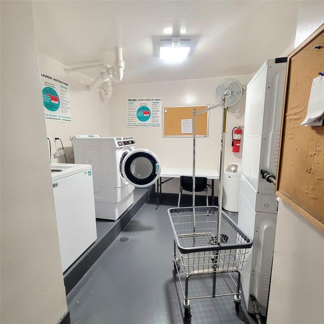 Shared laundry room with separate washer and dryer and a ceiling fan | Image 14