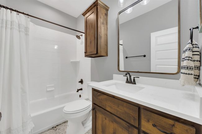 Full bath with shower / bath combination with curtain, toilet, and vanity | Image 8