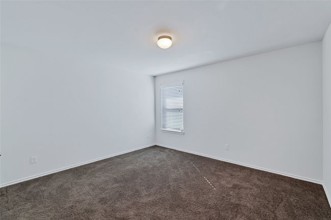 Spare room featuring dark carpet and baseboards | Image 22