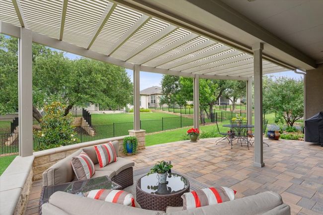 Fenced backyard featuring outdoor lounge area built to enjoy year round. | Image 33