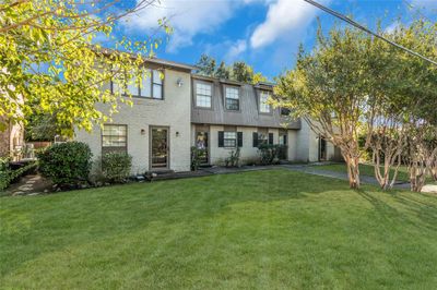 View of front of property with a front yard and a patio area | Image 1