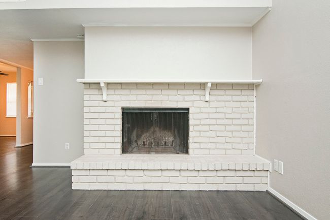 Interior details with crown molding, dark wood-type flooring, and a fireplace | Image 10