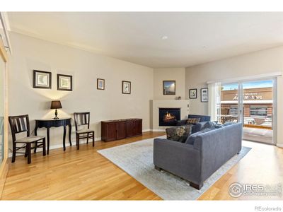 View of living room, gas fireplace and deck | Image 3