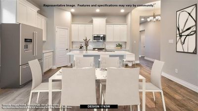 Kitchen featuring backsplash, appliances with stainless steel finishes, hardwood / wood-style flooring, an island with sink, and white cabinets | Image 3