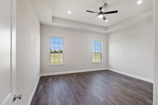 Spare room featuring baseboards, recessed lighting, dark wood-style floors, a ceiling fan, and a raised ceiling | Image 8