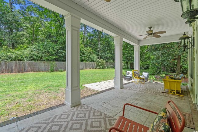 Fenced backyard with ceiling fan and a patio | Image 21