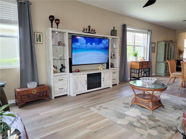 Living area featuring light wood-style flooring and ceiling fan | Image 17