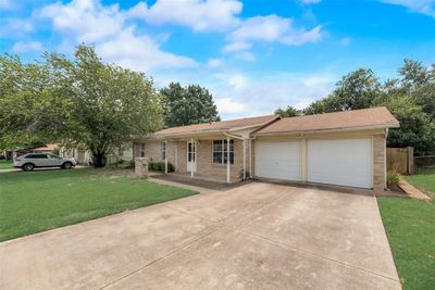 Single story home with a garage and a front yard | Image 1