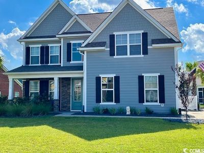 Craftsman-style house with a front lawn | Image 1