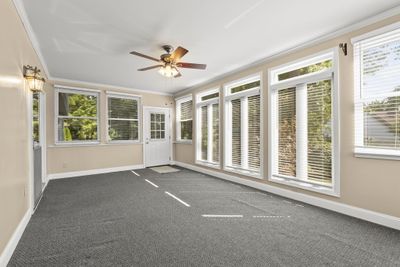 Gorgeous windows accent this lovely spacious sunroom. The present owners use this room multiple seasons by opening the door from the family room and sunroom. | Image 2