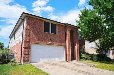 View of front facade with a garage and central air condition unit | Image 2