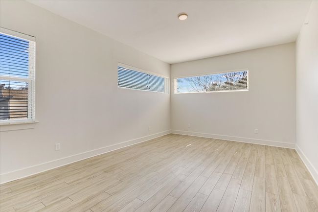 Empty room with light wood-style floors and baseboards | Image 11