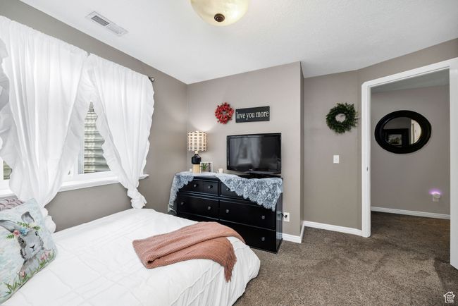 Bedroom featuring baseboards, visible vents, and carpet flooring | Image 29