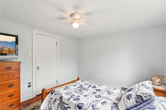 Bedroom with baseboards, visible vents, and ceiling fan | Image 20