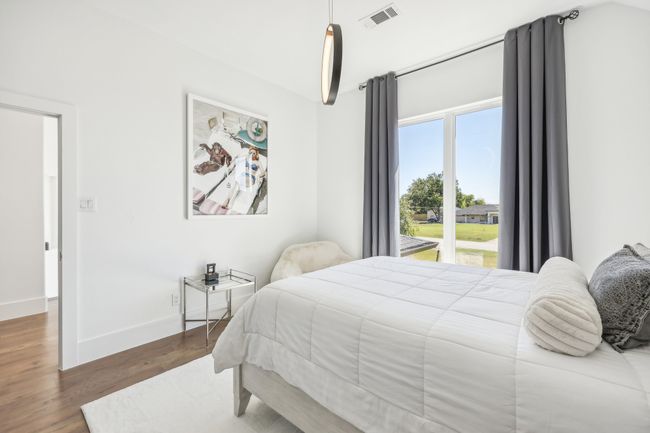 Bedroom featuring wood finished floors and baseboards | Image 25