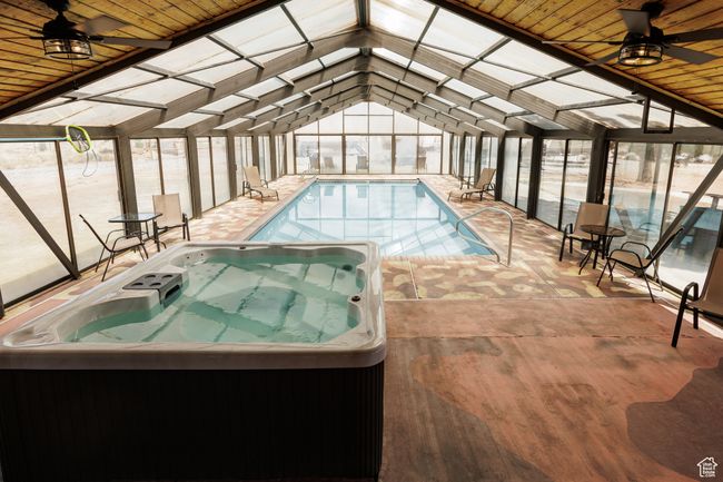 Indoor pool with an indoor hot tub | Image 11
