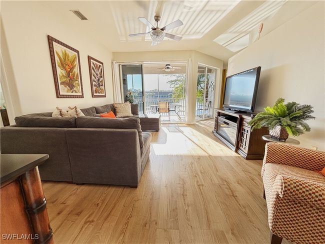 Warm toned Luxury Vinyl Plank flooring graces many of the home's living spaces. | Image 4