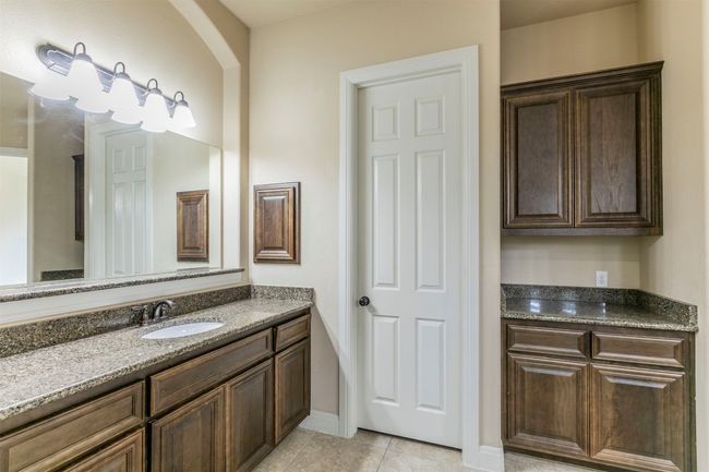 Bathroom with tile patterned floors, baseboards, and 2 split vanities | Image 20